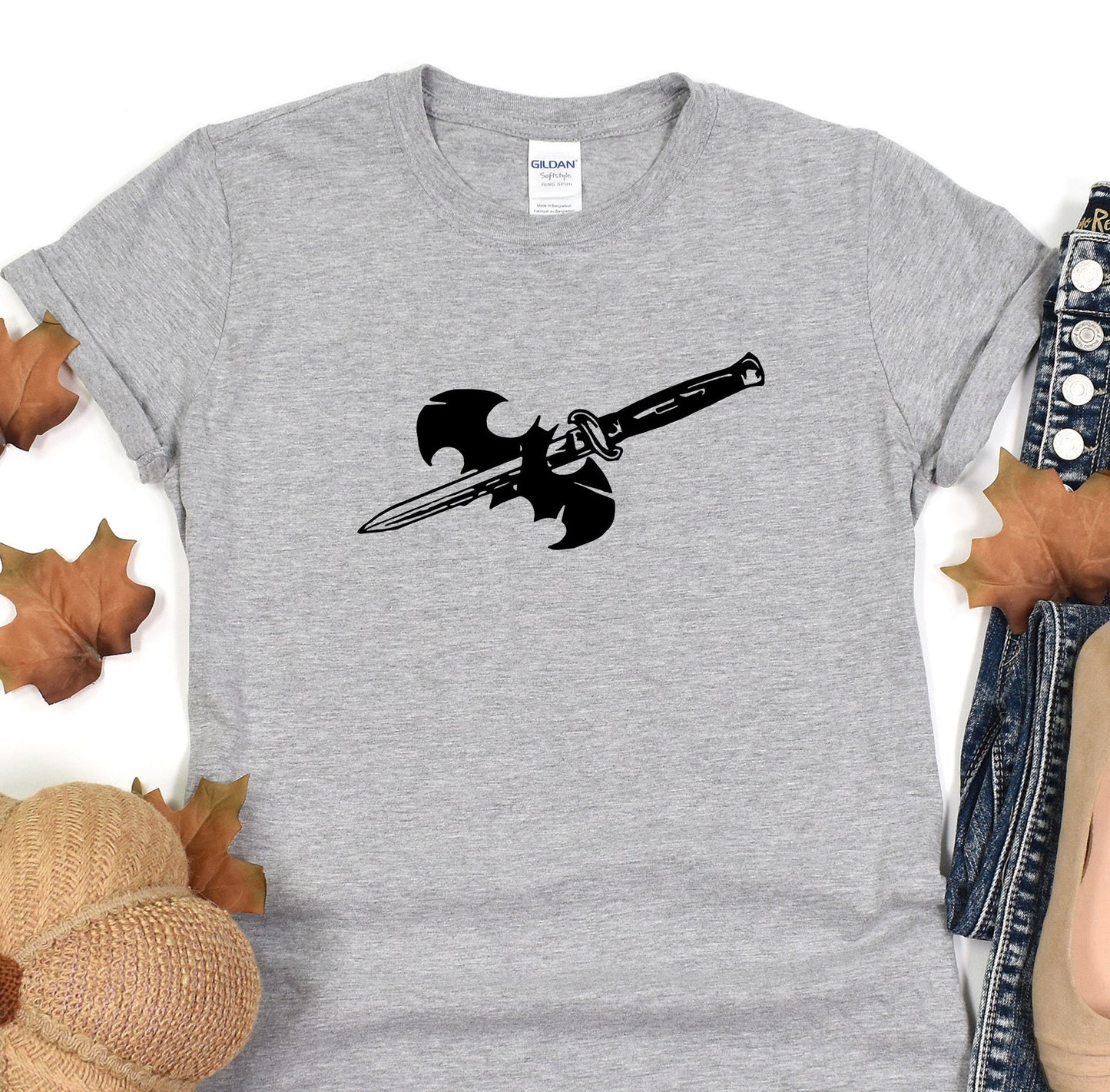 a gray t - shirt with a black sword on it