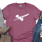 a t - shirt with a gun on it next to a pair of jeans