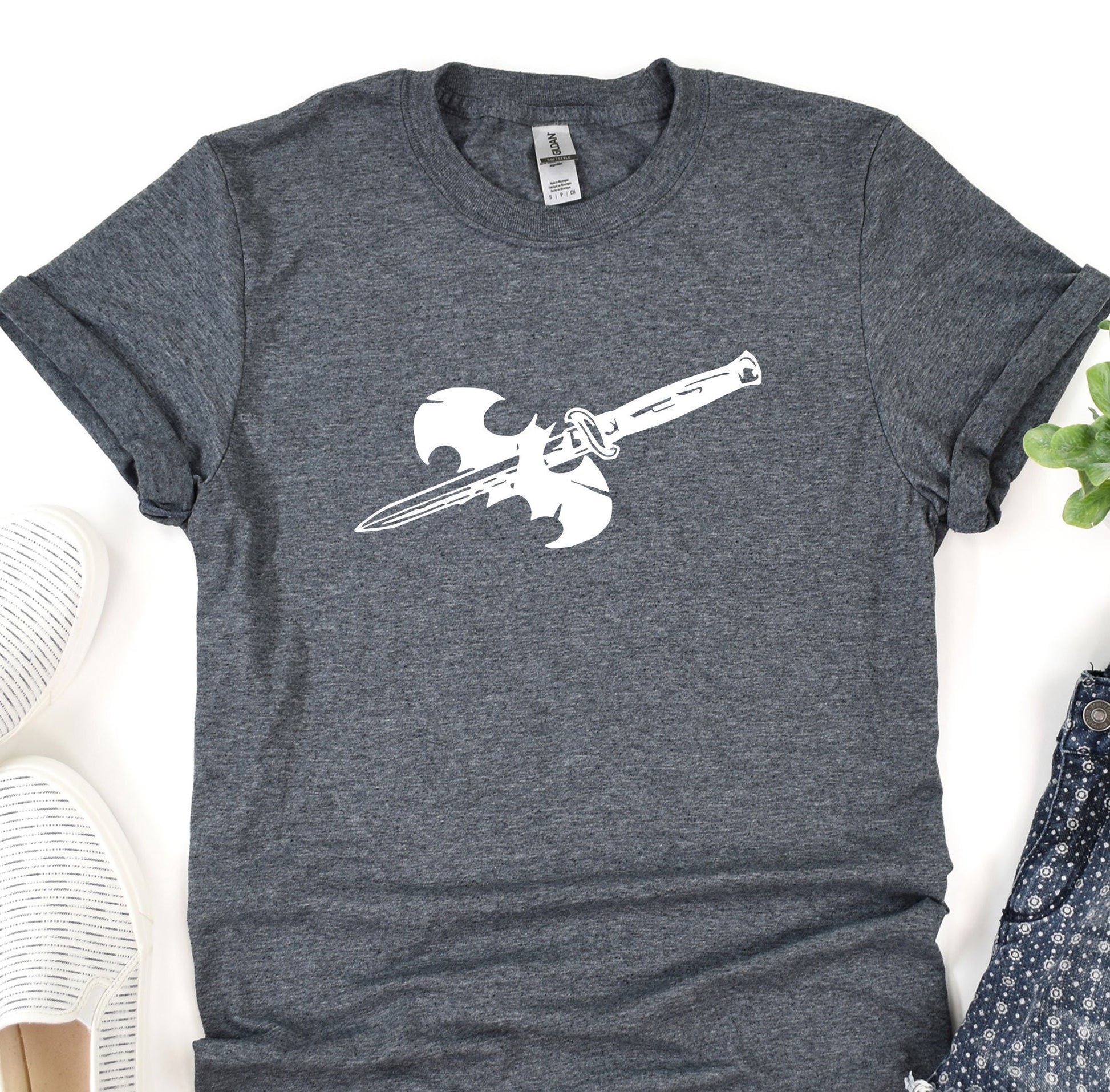 a t - shirt with a knife on it next to a pair of shoes