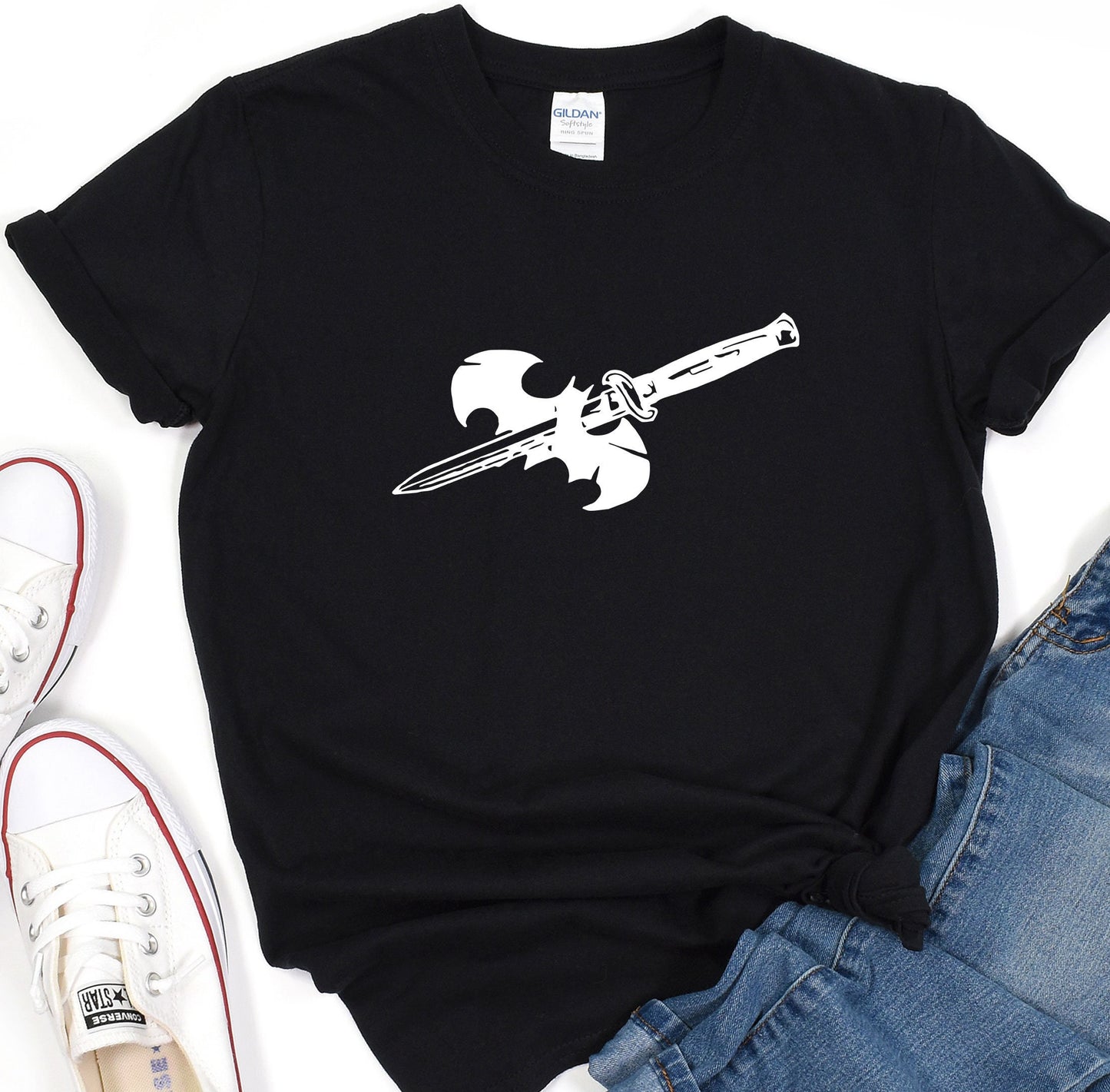 a black t - shirt with a sword on it