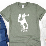 a t - shirt with a graphic of a man holding a gun