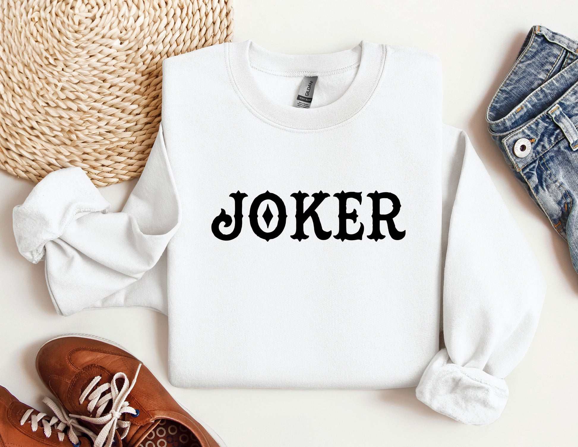 a white sweater with the word joker printed on it