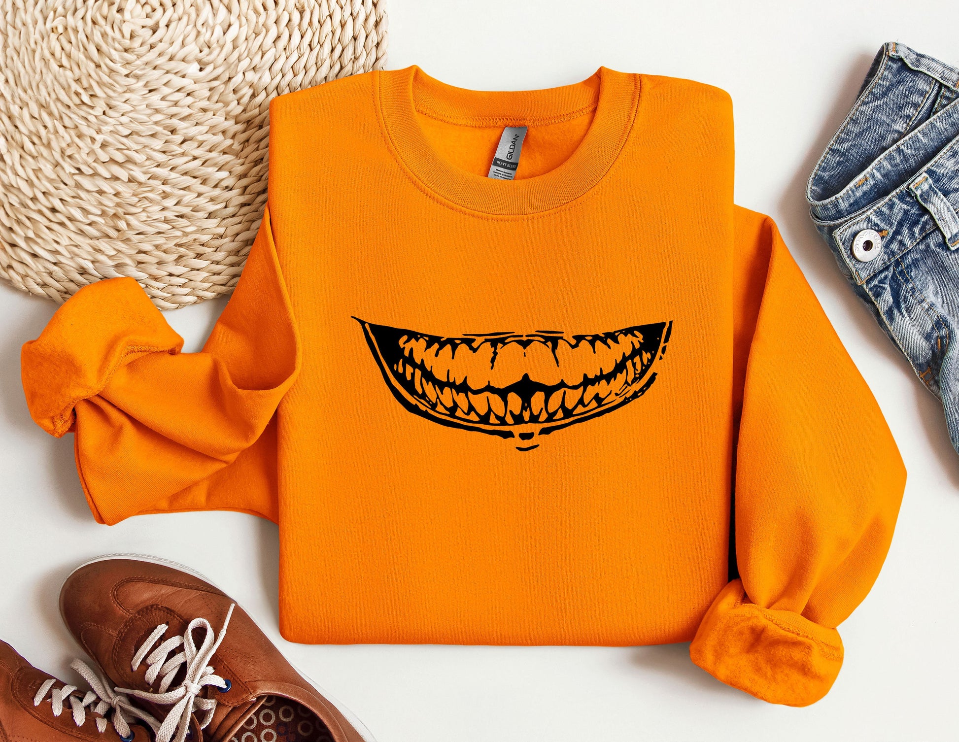 an orange shirt with a smile drawn on it