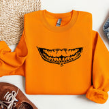 an orange shirt with a smile drawn on it