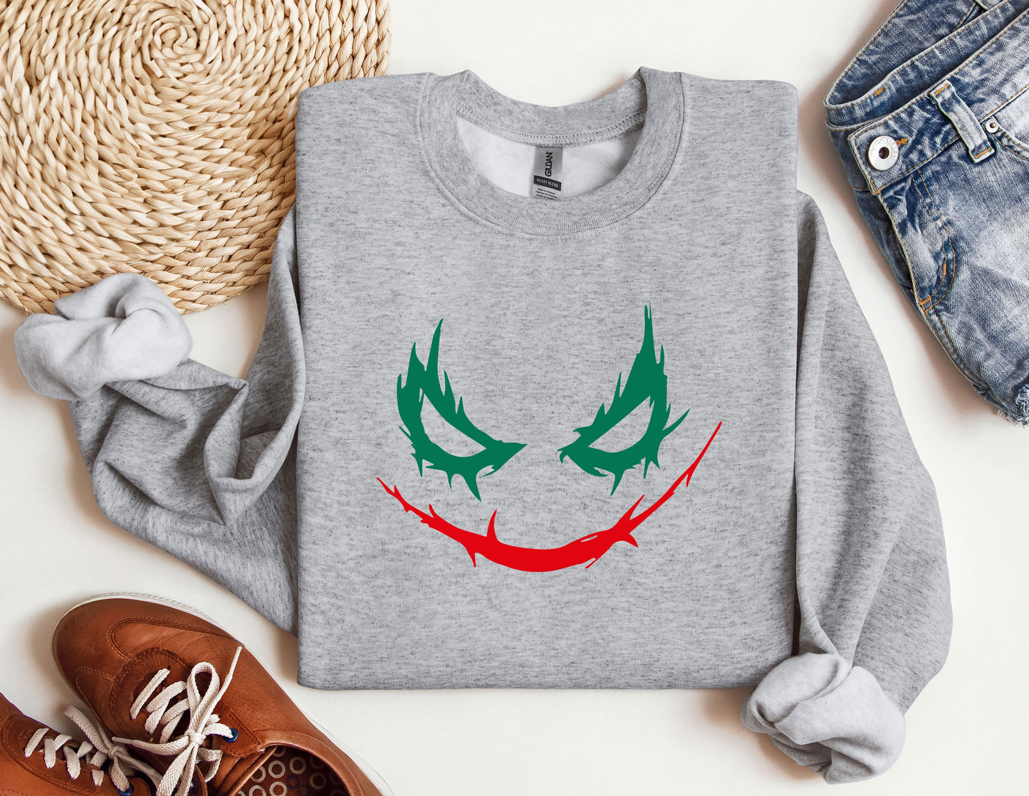 a sweater with a joker face painted on it