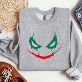 a sweater with a joker face painted on it