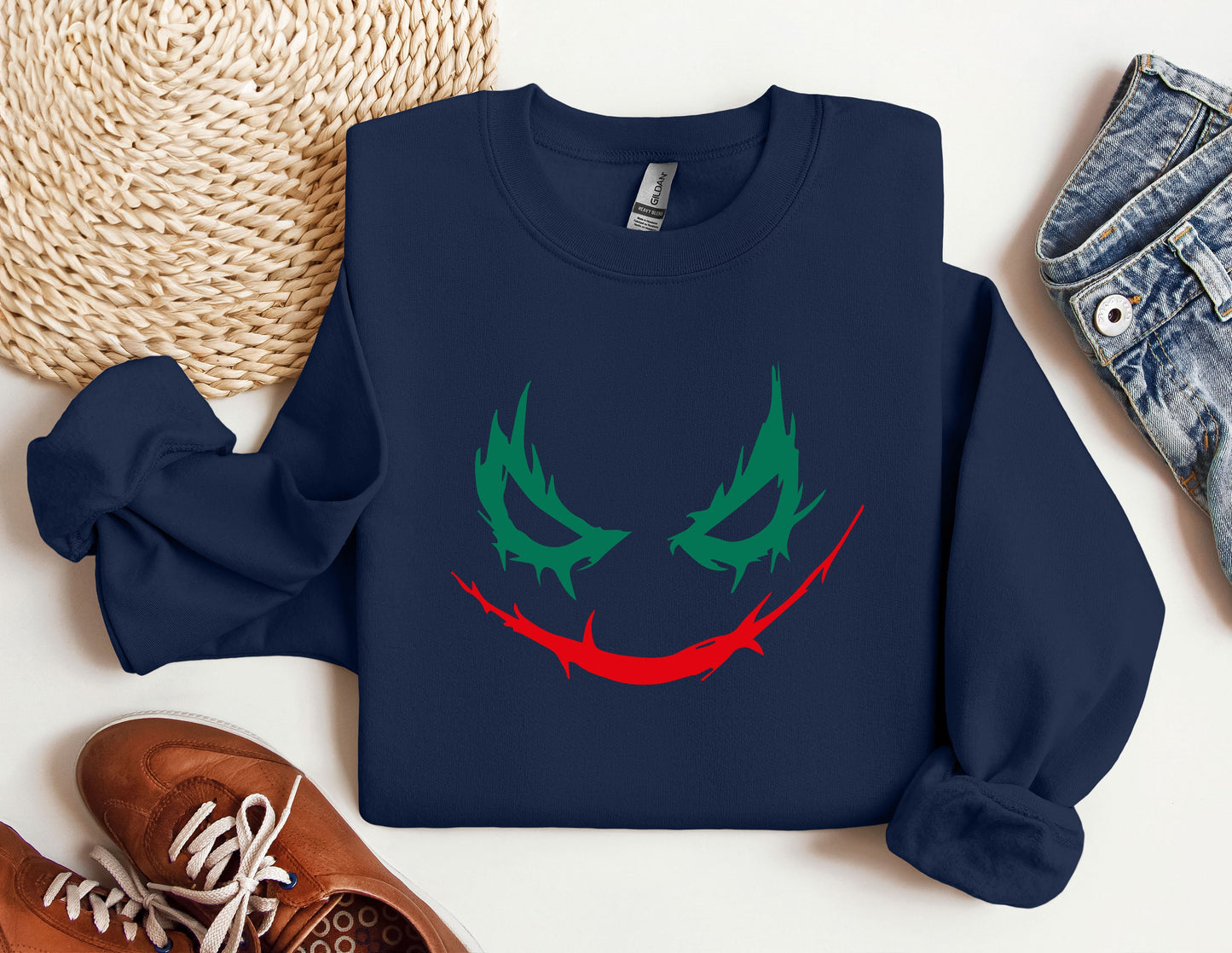 a blue sweatshirt with a red and green face on it