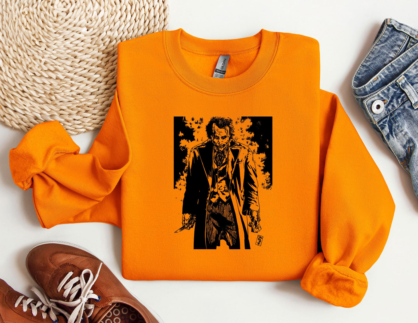 an orange shirt with a picture of a man holding a gun