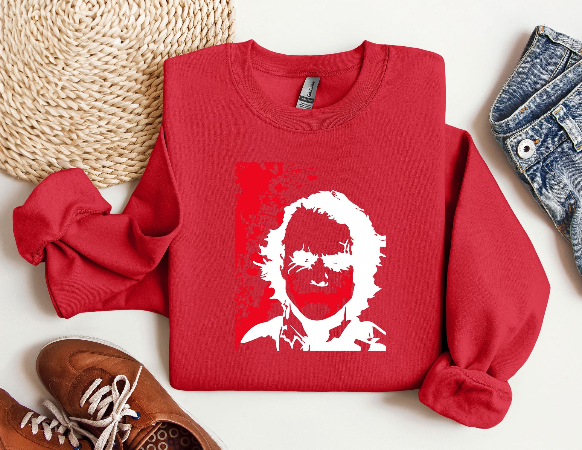 a red sweater with a picture of a man&#39;s face on it