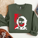 a green sweatshirt with a picture of a man's face on it