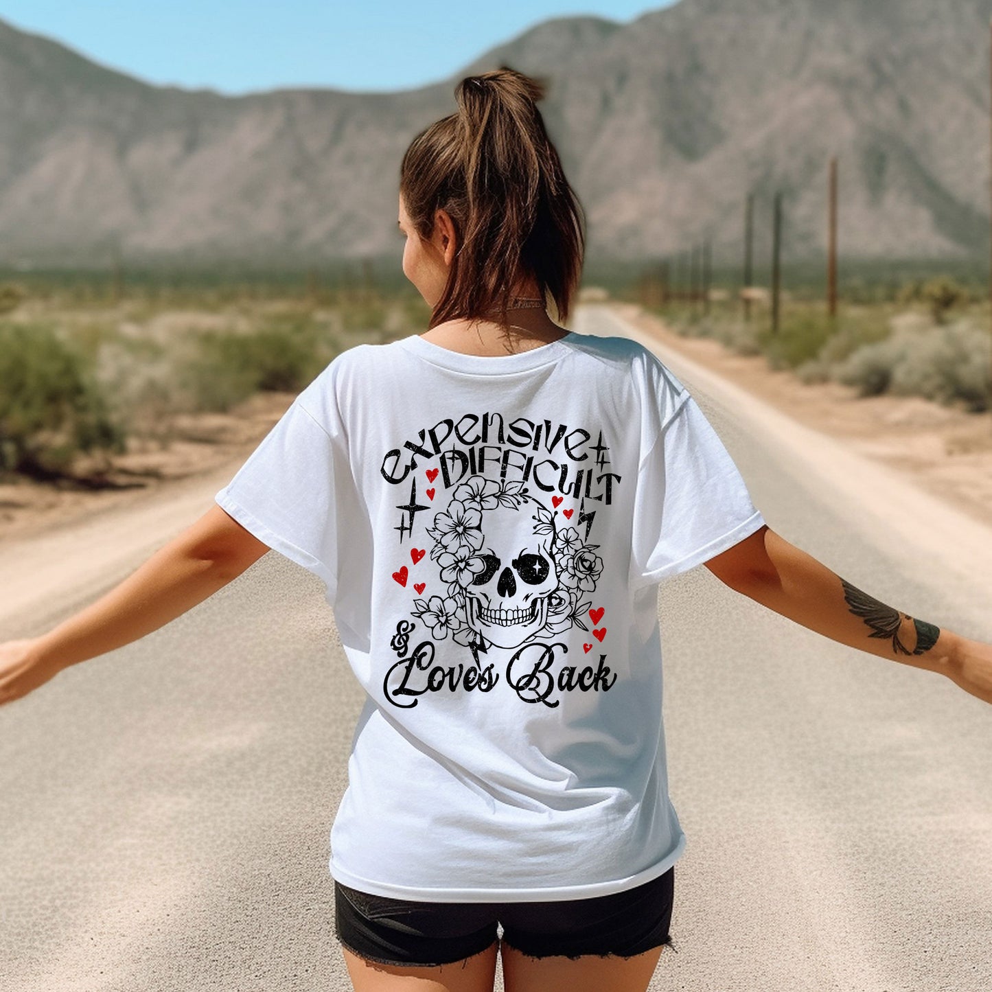 a woman walking down a road with her arms outstretched