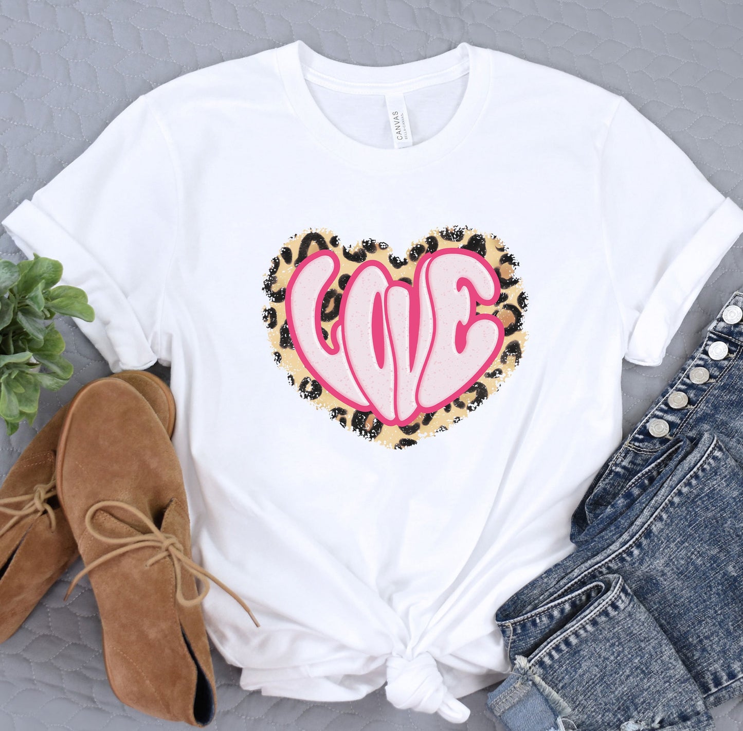 a white t - shirt with a pink heart on it