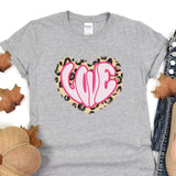 a gray shirt with a pink heart on it