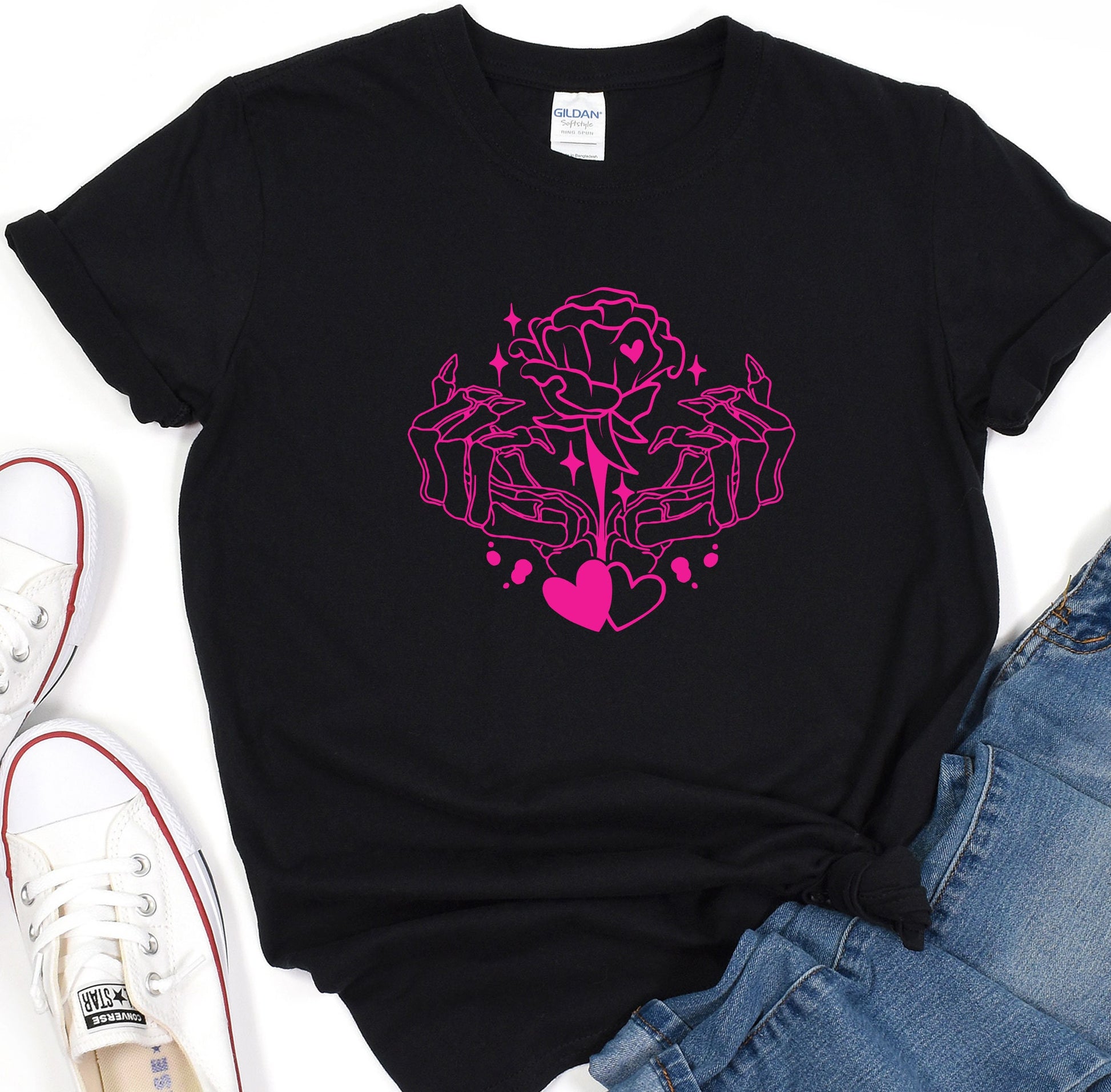 a black t - shirt with a pink design on it