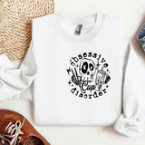 a white sweatshirt with a skull and a cross on it