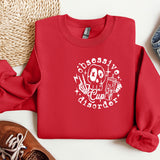 a red sweatshirt with a skull on it next to a pair of shoes