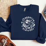 a blue sweatshirt with a skull on it next to a pair of shoes