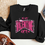a black shirt with a pink lettering on it