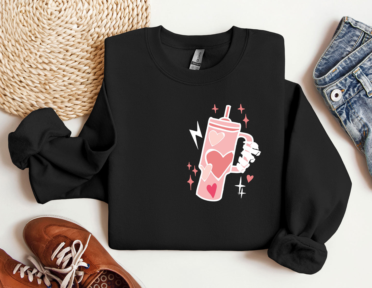 a black sweatshirt with a pink drink on it