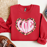a red sweater with a leopard print heart on it