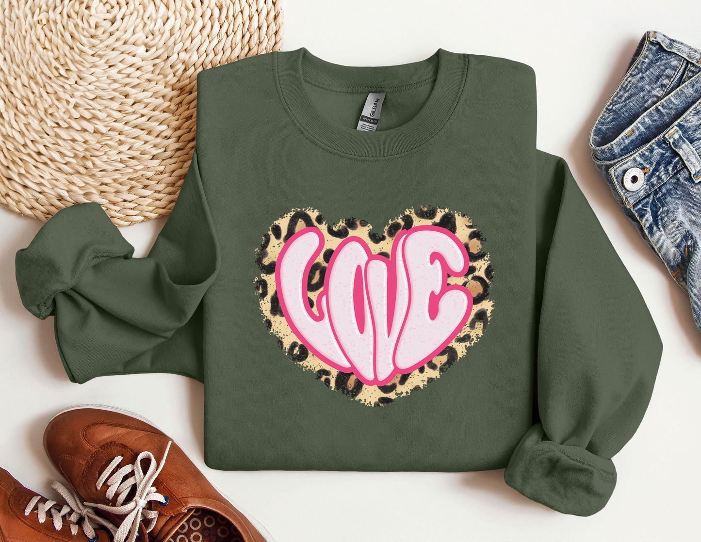 a green sweatshirt with a pink heart on it