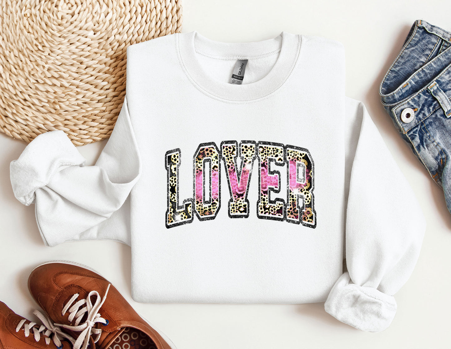 a white sweatshirt with the word loved printed on it