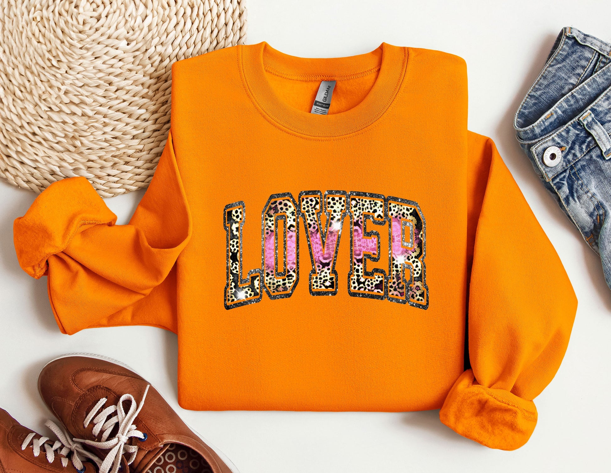 a pair of shoes and an orange sweatshirt with the word love on it