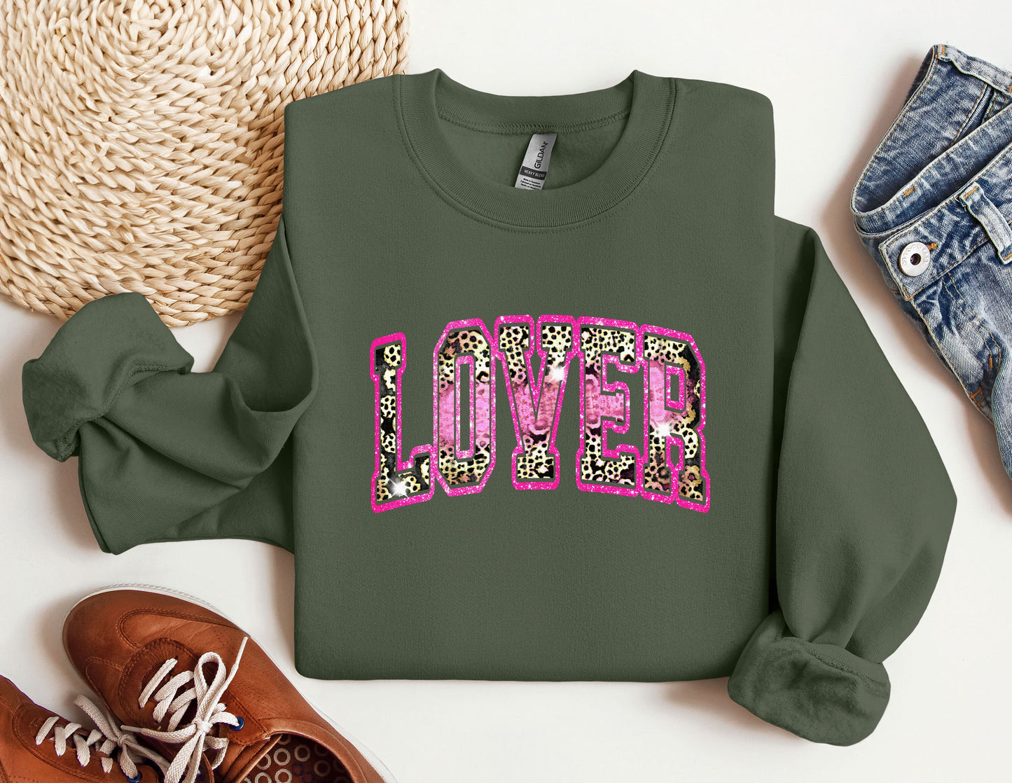 a green sweatshirt with pink leopard print on it