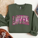 a green sweatshirt with pink leopard print on it