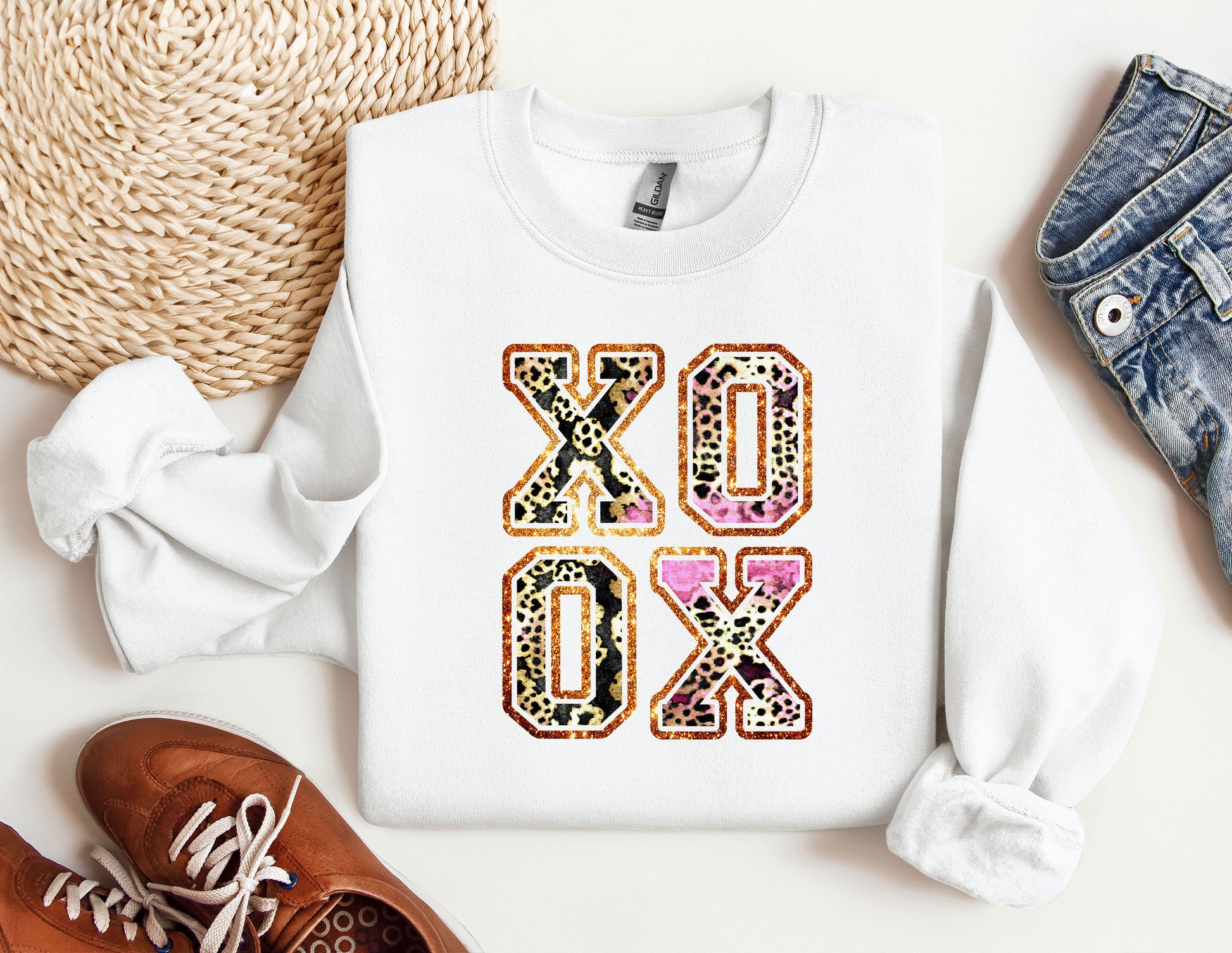 a white sweatshirt with the word oxox printed on it