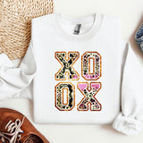 a white sweatshirt with the word oxox printed on it