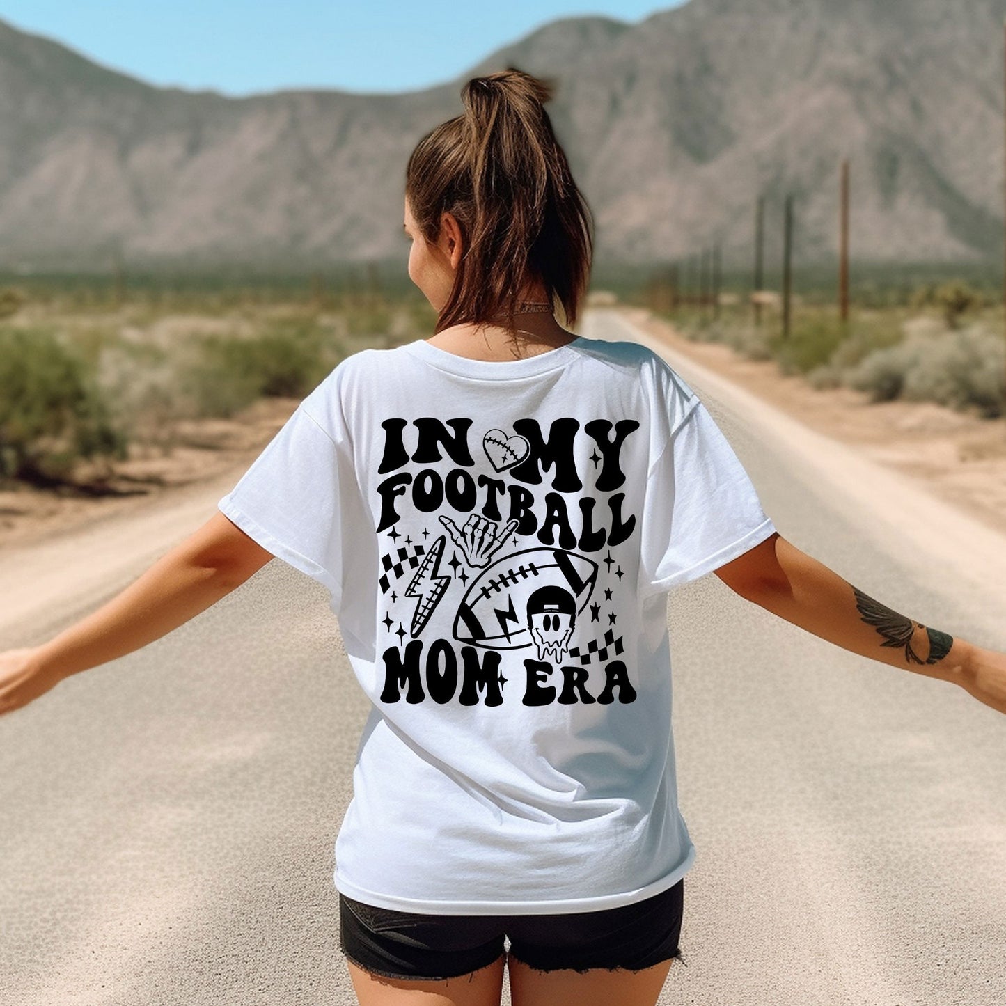 a woman walking down a road with her arms outstretched