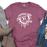 a t - shirt that says football mom with a skull on it