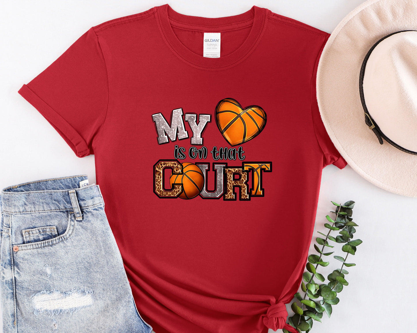 a red shirt with a basketball and a hat