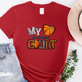 a red shirt with a basketball and a hat