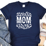 a t - shirt with the words mom on it next to a pair of jeans