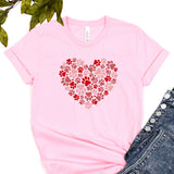 a pink t - shirt with a heart made out of paw prints