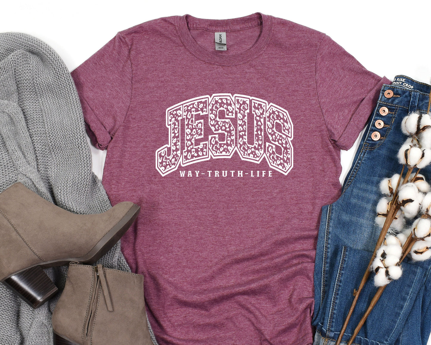 a t - shirt with the word jesu on it next to a pair of