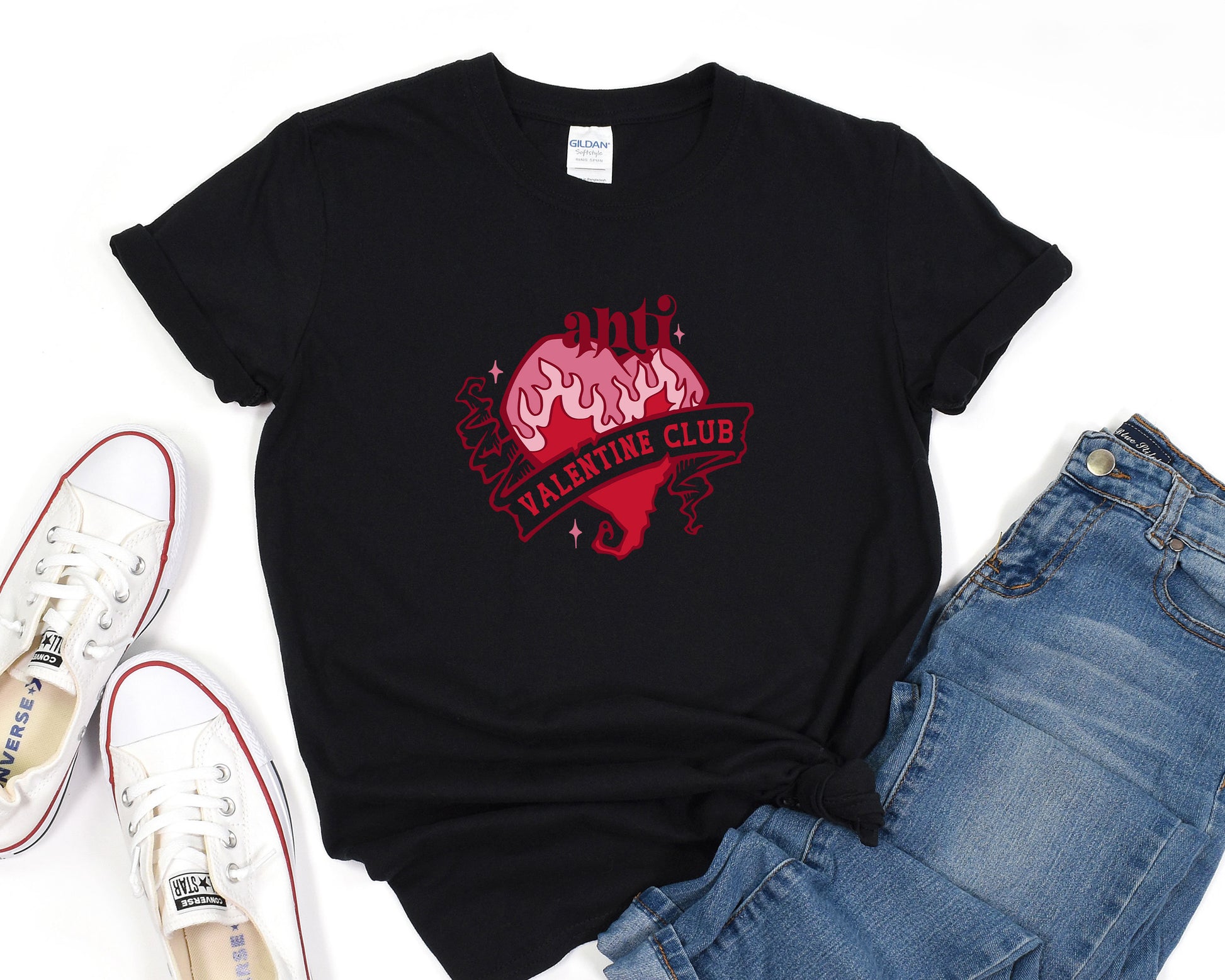 a black t - shirt with a pink heart on it