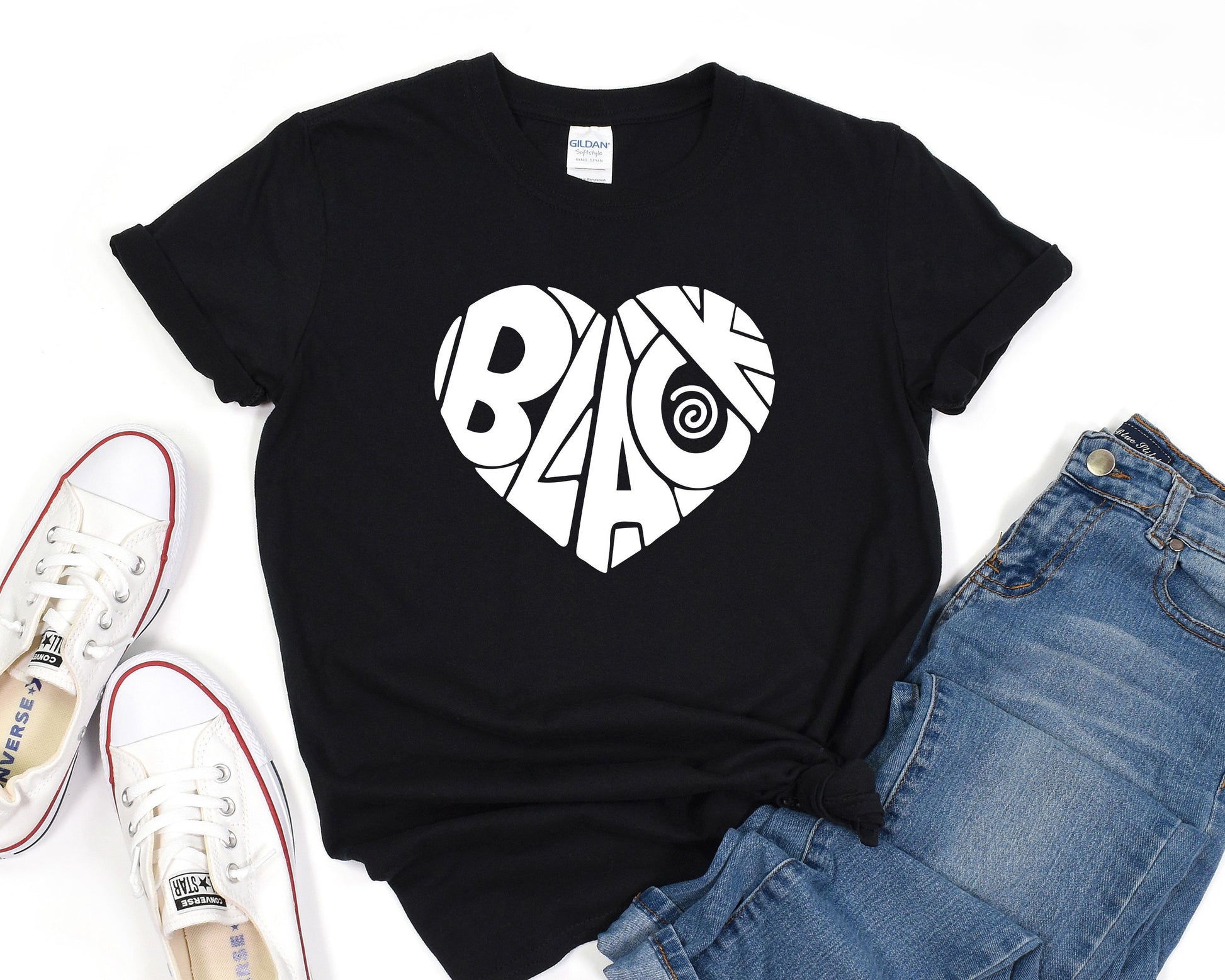 a black t - shirt with a white heart and the word blac on