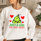 a woman sitting on a bed wearing a white sweatshirt