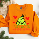 an orange sweater with a grin face on it
