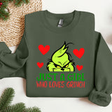 a green grin face with red hearts on it