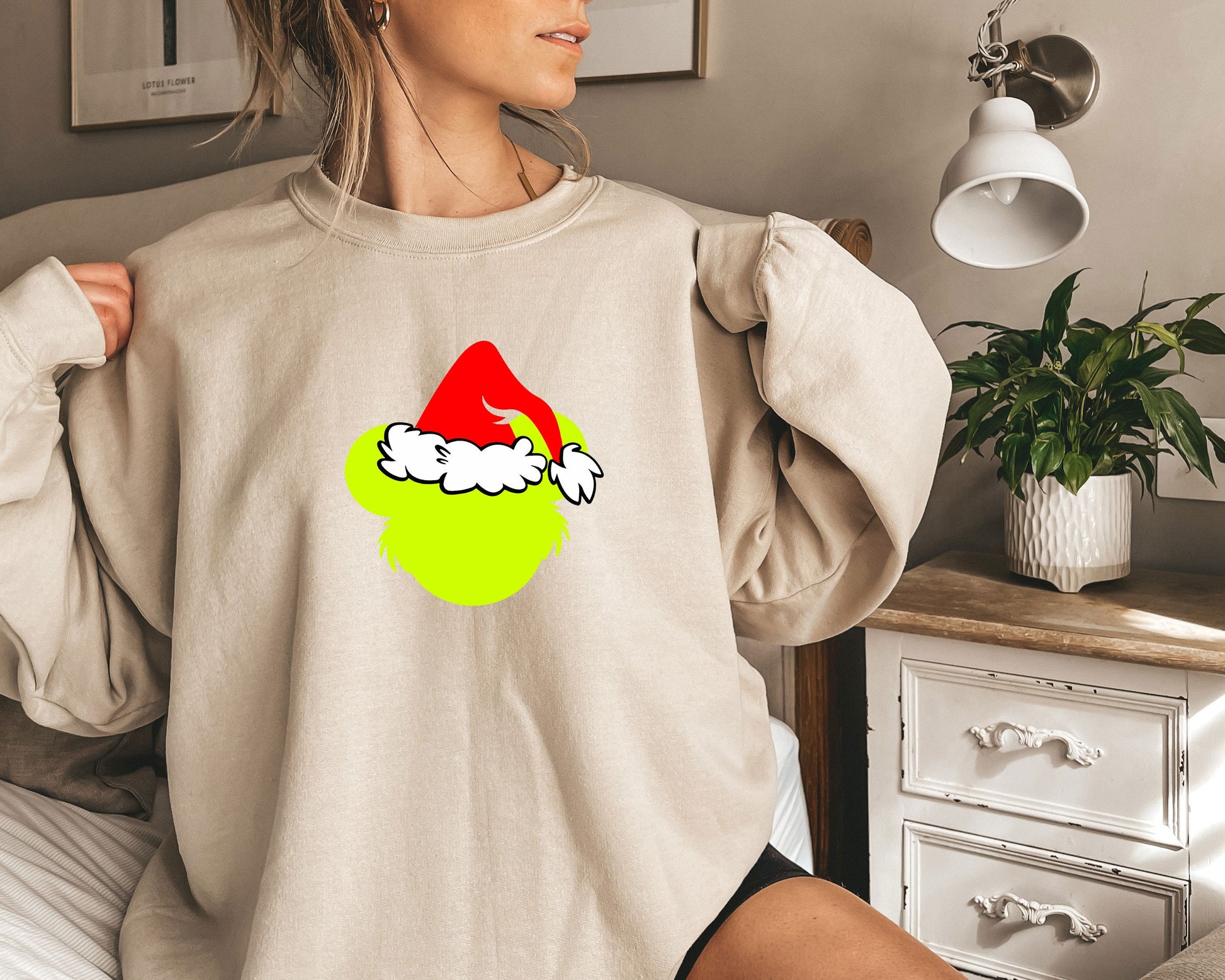 a woman wearing a sweatshirt with a santa hat on it