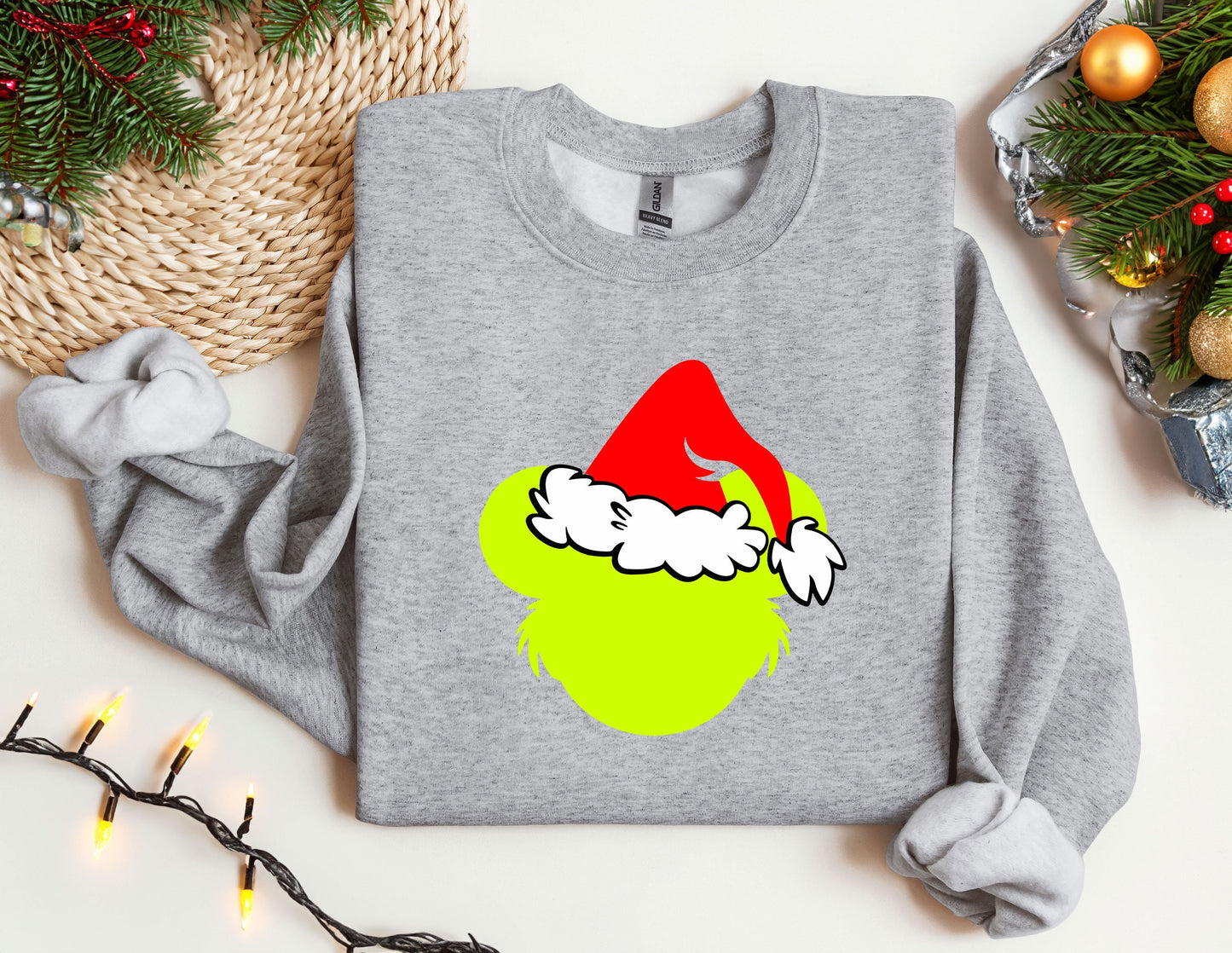 a grey sweatshirt with a green apple wearing a santa hat