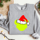 a grey sweatshirt with a green apple wearing a santa hat