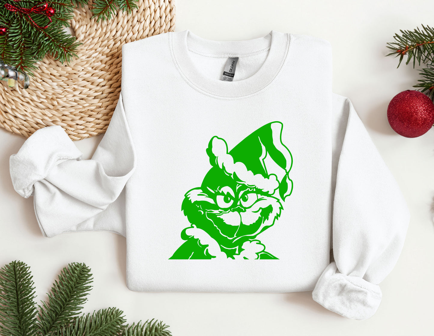 a white sweatshirt with a green image of a cat on it