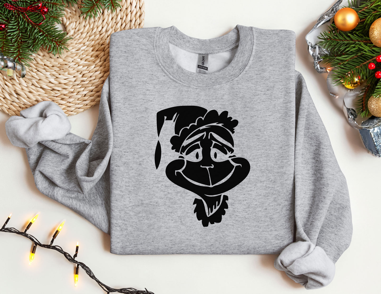 a grey sweatshirt with a cartoon of a man wearing a santa hat