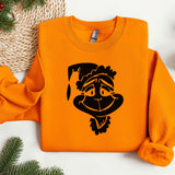 an orange sweater with a cartoon of a monkey wearing a santa hat