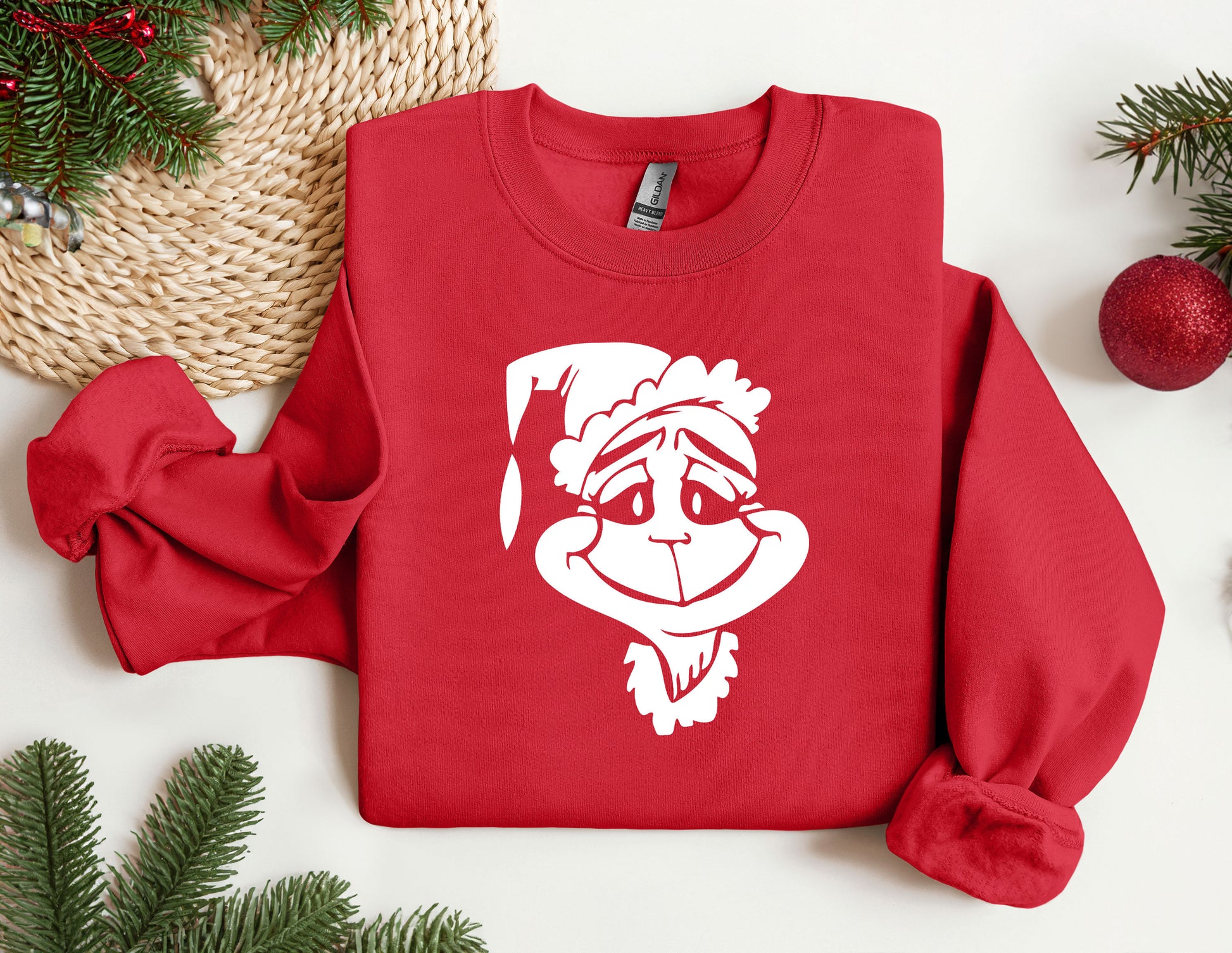 a red sweatshirt with a santa claus face on it